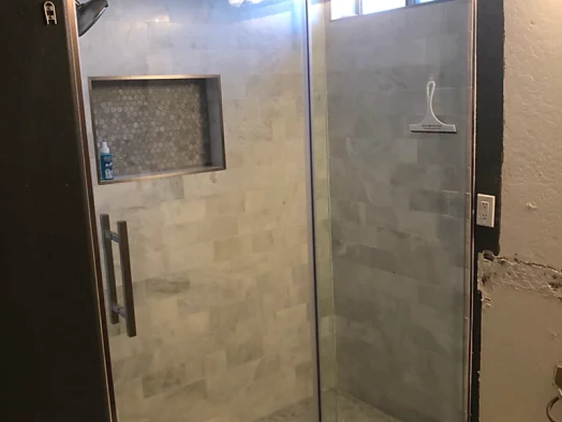 beige shower room with a glass door and some hints of brown