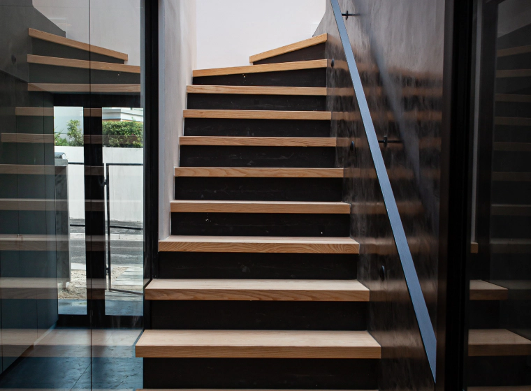 wood stairs with an iron black railing